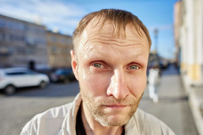 Close-up portrait of mid adult man in city