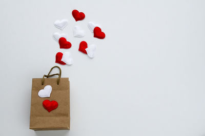 Directly above shot of heart shapes on white background