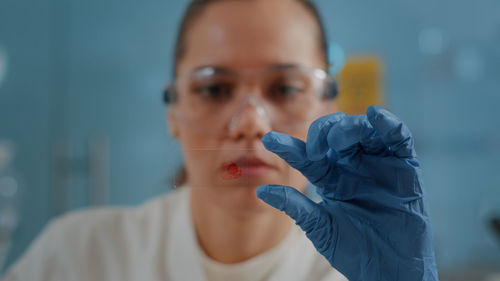 Close-up of scientist holding blood sample