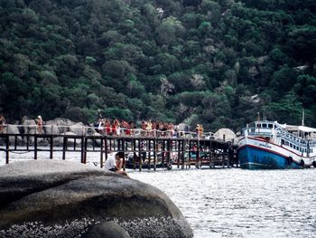 View of boats in sea against trees