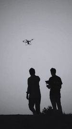 Low angle view of silhouette man standing against sky