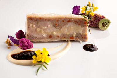 Close-up of pastry over white background