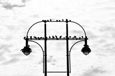 Low angle view of illuminated light bulb against sky