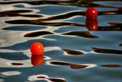 High angle view of orange buoys floating in river