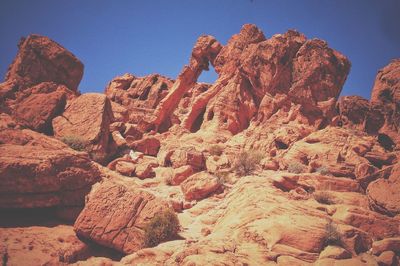 Low angle view of rock formation against clear sky