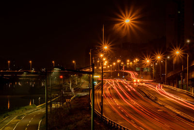 Light trails on road against sky at night, 