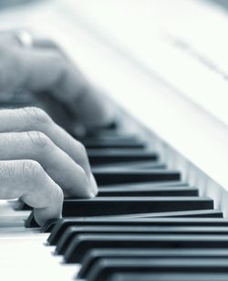 Close-up of hands playing piano