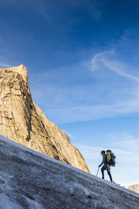 Backpacker ascending glacier on baffin island, canada.