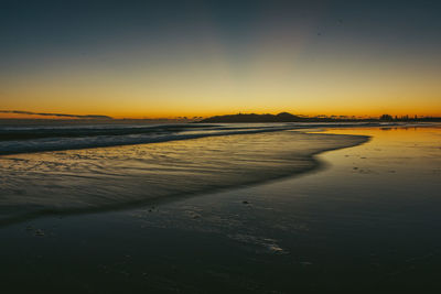 View of calm beach at sunset