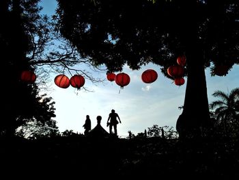 Low angle view of hanging lanterns against sky