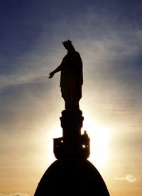 Low angle view of silhouette statue against sky during sunset