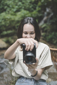 Series photo of young woman photographer with her camera shooting photo outdoor