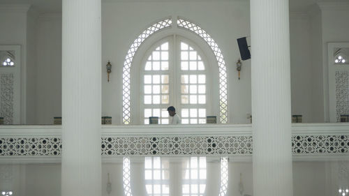 Reflection of people on window of building