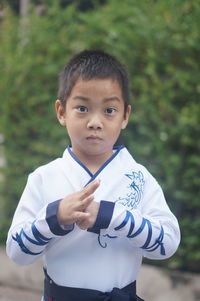 Portrait of cute boy standing outdoors