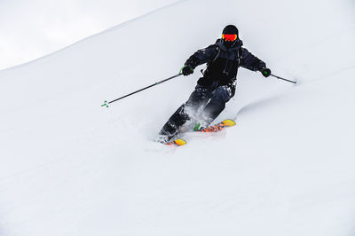 Man skiing on snow covered field