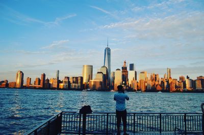 Man looking at modern buildings in city