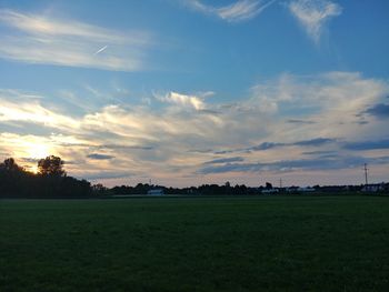 Scenic view of field against sky during sunset