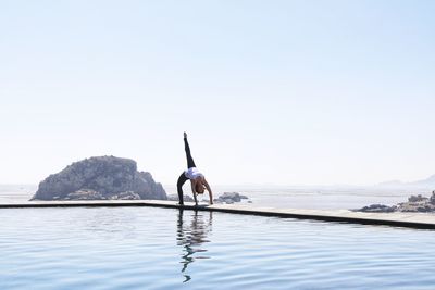 Man in sea against clear sky