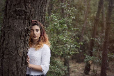 Portrait of young woman in forest