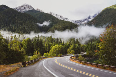 Morning mist over a mountain road in vintage style