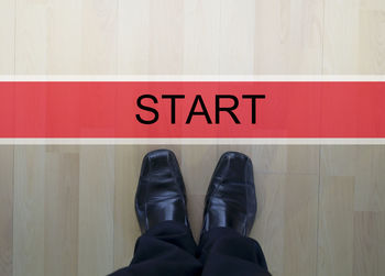 Low section of man standing on floor