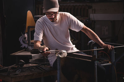 Man working on glass at workshop