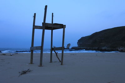 Lifeguard hut on beach against clear sky