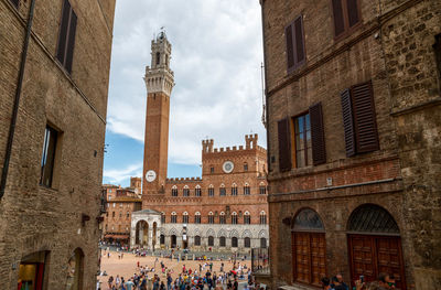 Siena, tuscany, italy. august 2020. view of piazza del campo, the torre del mangia is evidently .