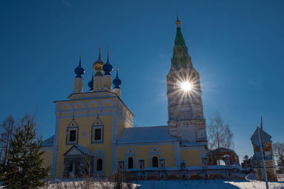 Clock tower of building against blue sky