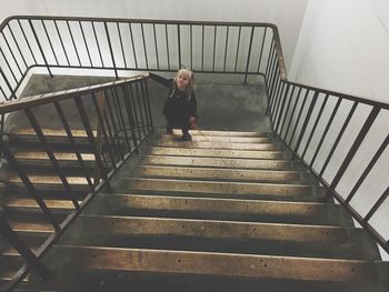 High angle view of girl walking on staircase