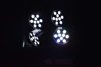 Close-up of illuminated lamp in dark room