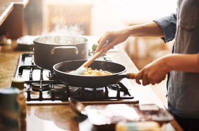 Midsection of man preparing food in kitchen