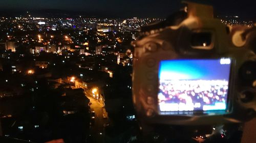 Woman in illuminated city at night