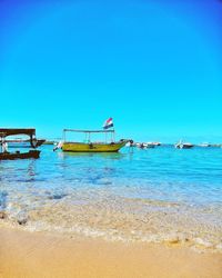 Scenic view of sea against clear blue sky