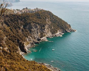 High angle view of rocks on sea shore
