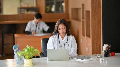 Doctor using laptop at hospital