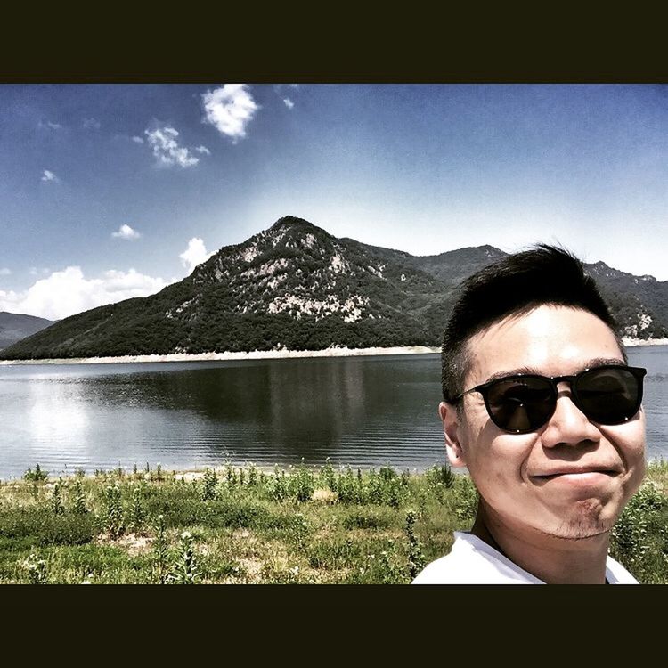 lifestyles, leisure activity, sunglasses, mountain, young adult, person, water, lake, headshot, sky, reflection, mountain range, looking at camera, portrait, young men, front view, head and shoulders