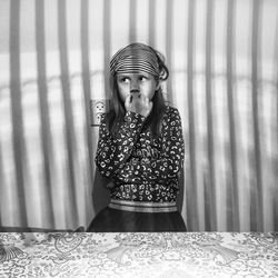 Portrait of a young woman sitting on table