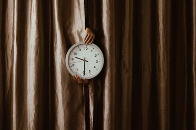 Close-up of clock on wood at home