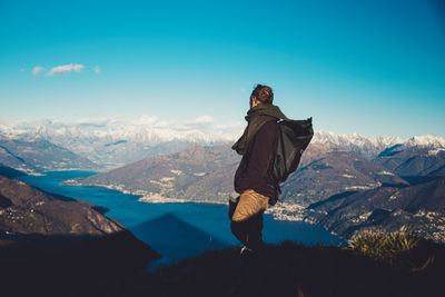 Side view of man standing against valley