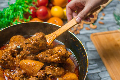 Cropped hand of person preparing food