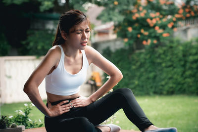 Young woman sitting outdoors