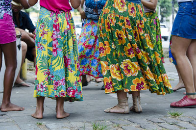 Low section of people dancing on street