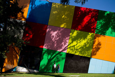 Close-up of multi colored umbrellas against sky