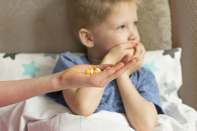 Close-up of boy lying on bed