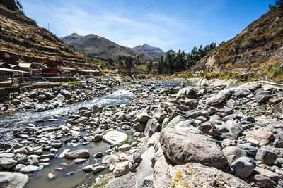 Scenic view of river amidst mountains against sky