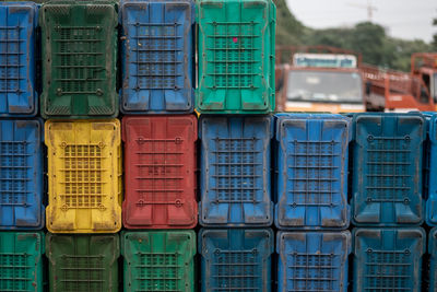 Stack of colorful dirty crates at market