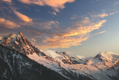 Scenic view of snowcapped mountains against sky during sunset