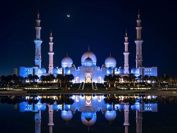 Illuminated building against sky at night