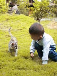 Full length of boy on grass in farm